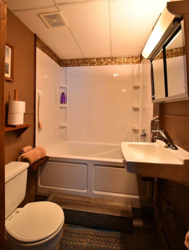 full bathroom with visible vents, a sink, toilet, and tub / shower combination