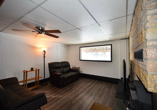 interior space with ceiling fan, dark wood-type flooring, and a drop ceiling