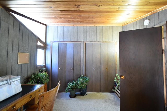 carpeted office with wood walls and wood ceiling