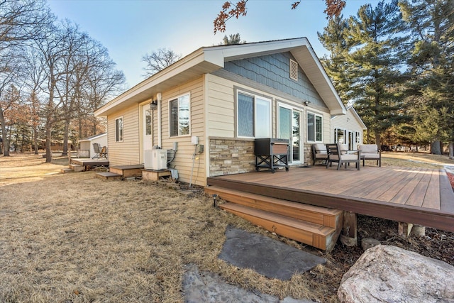 exterior space featuring stone siding and a deck