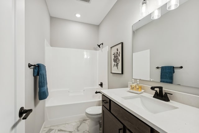 full bathroom with marble finish floor, tub / shower combination, vanity, and toilet