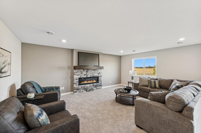 living room with light colored carpet, a stone fireplace, baseboards, and a textured ceiling