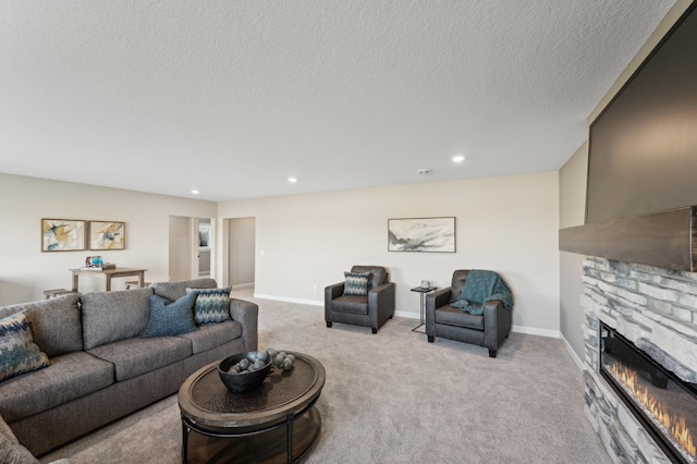 living room with a textured ceiling, a stone fireplace, recessed lighting, light colored carpet, and baseboards