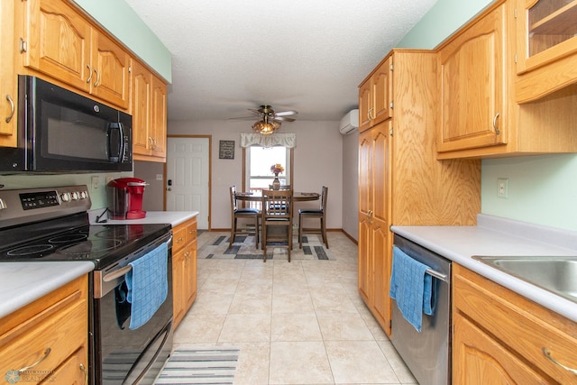 kitchen featuring light tile patterned floors, ceiling fan, stainless steel appliances, a textured ceiling, and light countertops