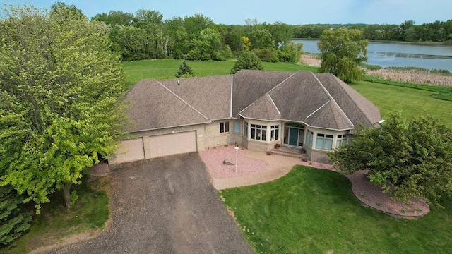 13380 Willandale Rd, Rogers, MN 55374 - view of front of house featuring a garage, a water view, driveway, and a front yard