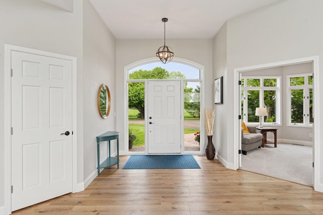 13380 Willandale Rd, Rogers, MN 55374 - entrance foyer with light wood-style floors, baseboards, and a chandelier