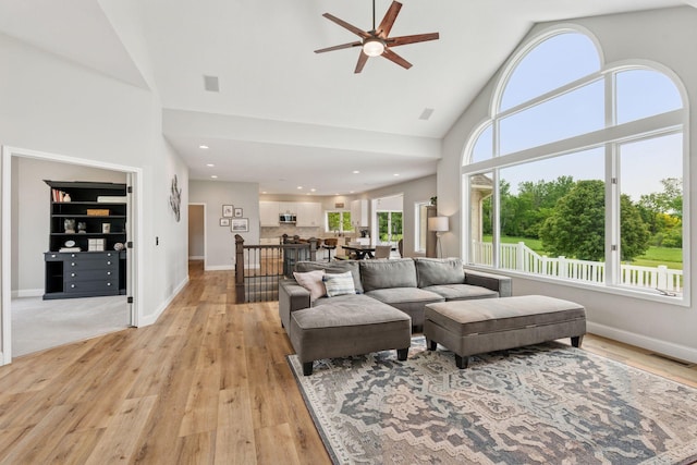 13380 Willandale Rd, Rogers, MN 55374 - living area with high vaulted ceiling, a ceiling fan, light wood finished floors, baseboards, and recessed lighting