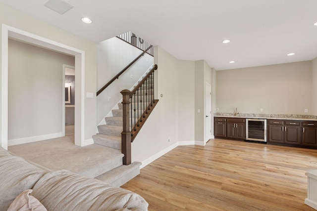 13380 Willandale Rd, Rogers, MN 55374 - indoor wet bar with beverage cooler, stairway, light wood finished floors, recessed lighting, and baseboards