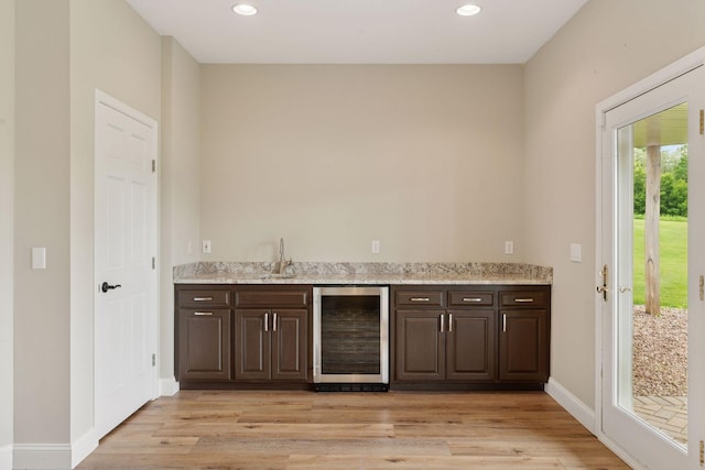 13380 Willandale Rd, Rogers, MN 55374 - indoor wet bar with beverage cooler, light wood-style flooring, recessed lighting, and baseboards
