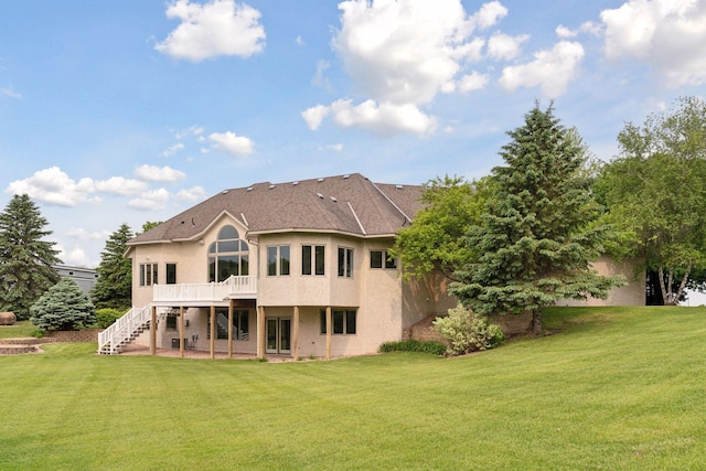 13380 Willandale Rd, Rogers, MN 55374 - rear view of house featuring stucco siding, a yard, stairway, and a wooden deck