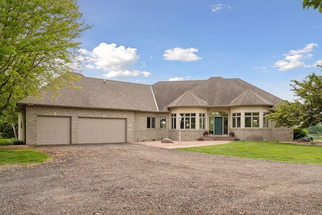 13380 Willandale Rd, Rogers, MN 55374 - view of front of house featuring driveway, an attached garage, brick siding, and a front yard