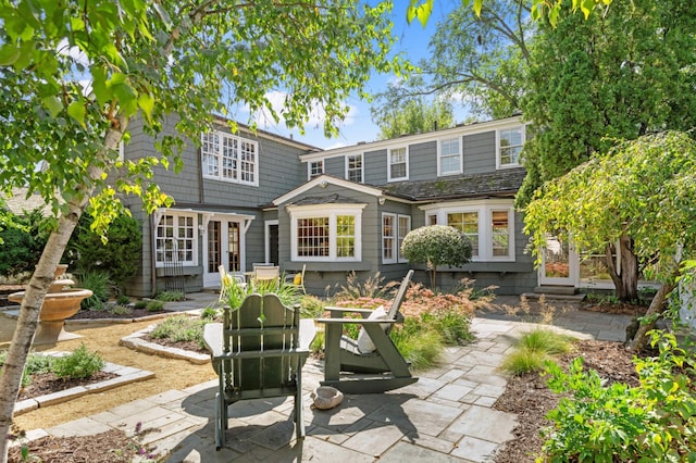 back of property with a patio and french doors