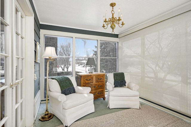 sitting room with a notable chandelier and carpet flooring