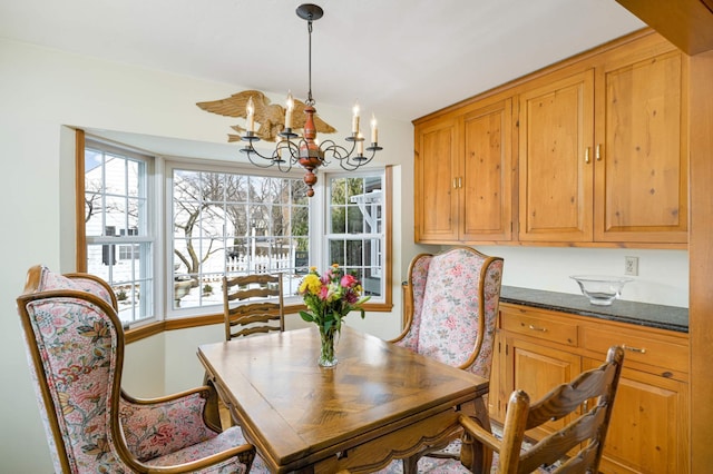 dining space with plenty of natural light and a notable chandelier