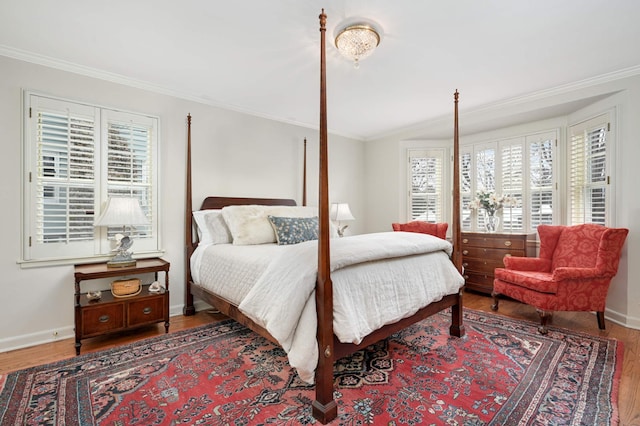 bedroom featuring multiple windows, crown molding, and wood finished floors