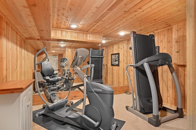 exercise area featuring wood ceiling and wooden walls