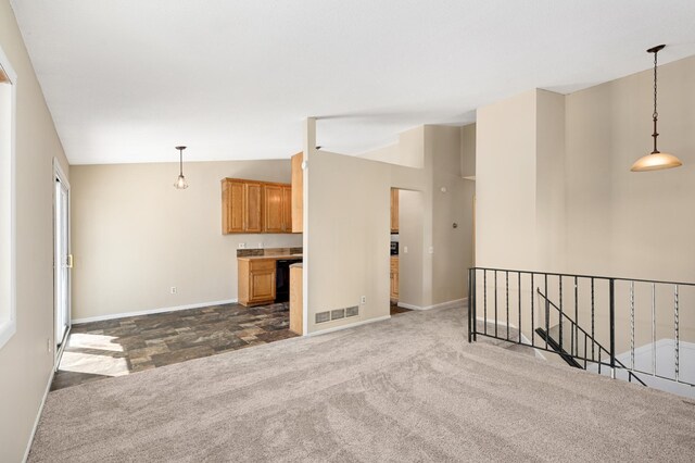 16860 Grenadier Ave, Lakeville, MN 55044 - unfurnished living room featuring baseboards, visible vents, dark carpet, and vaulted ceiling