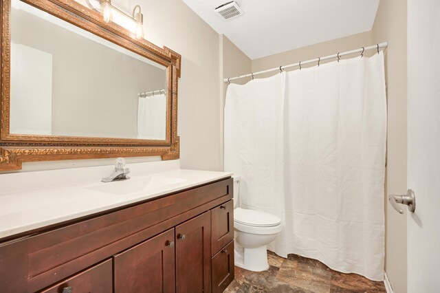 16860 Grenadier Ave, Lakeville, MN 55044 - bathroom with stone finish floor, visible vents, toilet, and vanity