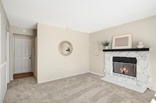 16860 Grenadier Ave, Lakeville, MN 55044 - unfurnished living room featuring carpet, baseboards, a textured ceiling, visible vents, and a fireplace