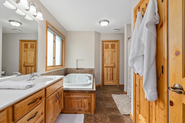 full bathroom with visible vents, stone finish floor, a garden tub, and vanity