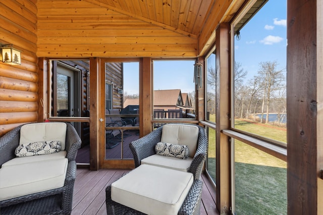 sunroom featuring lofted ceiling and wooden ceiling