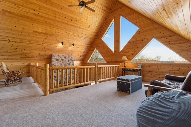 sitting room featuring carpet floors, wood walls, wooden ceiling, and lofted ceiling