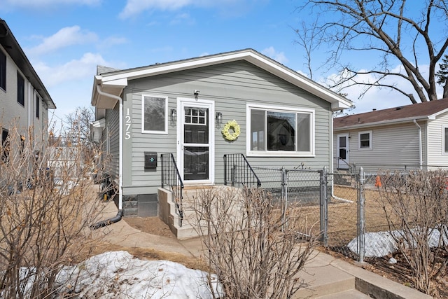 shotgun-style home featuring a gate and fence