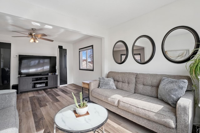 living room featuring wood finished floors and ceiling fan