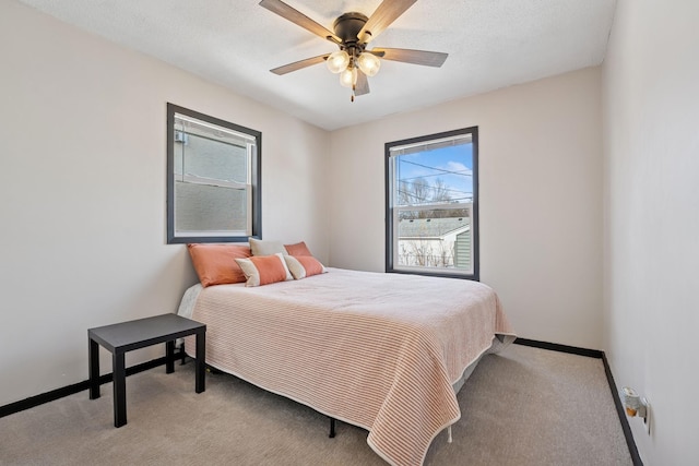 bedroom featuring carpet flooring, ceiling fan, a textured ceiling, and baseboards