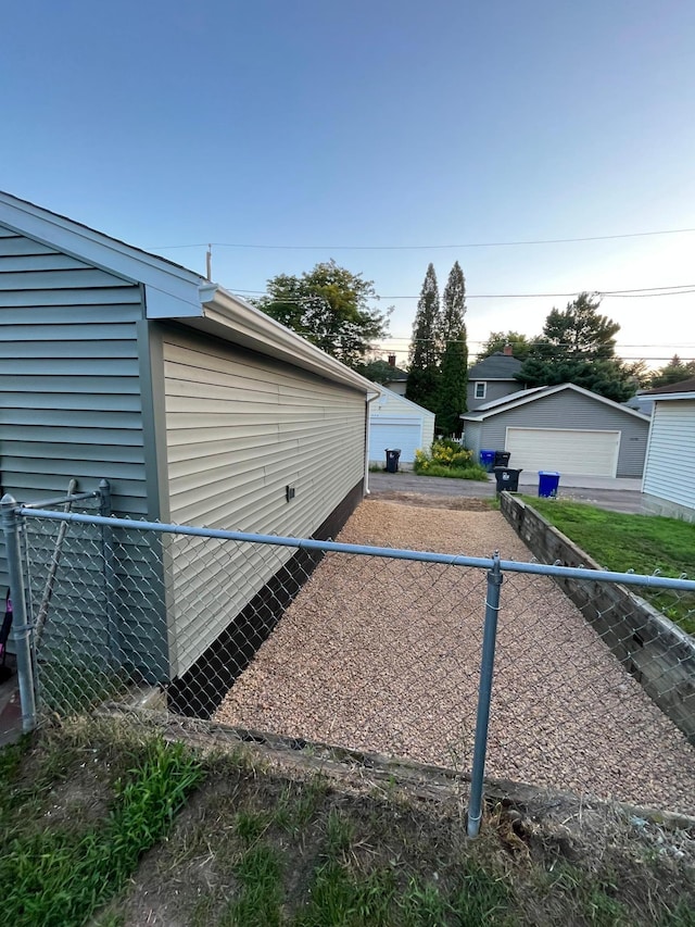 exterior space featuring a garage and fence