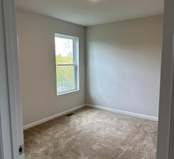 carpeted empty room with baseboards