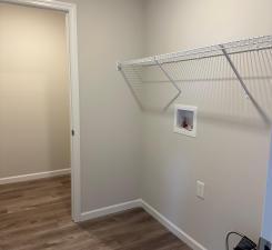 washroom featuring laundry area, baseboards, washer hookup, and dark wood finished floors