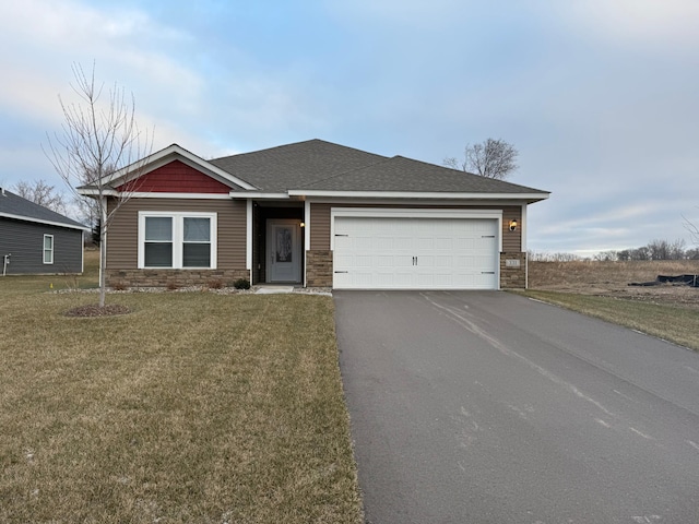 view of front of house with a garage, stone siding, a front yard, and driveway