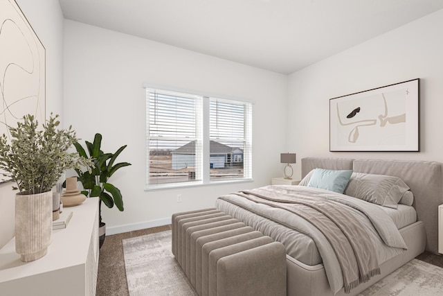 bedroom featuring carpet floors and baseboards