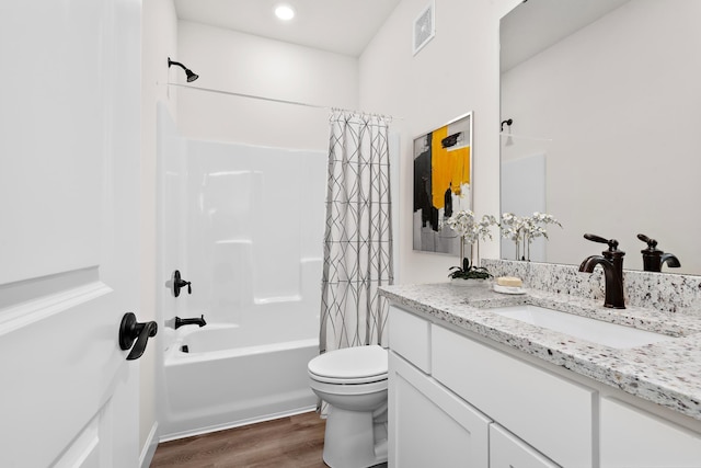 bathroom featuring visible vents, toilet, shower / tub combo with curtain, wood finished floors, and vanity