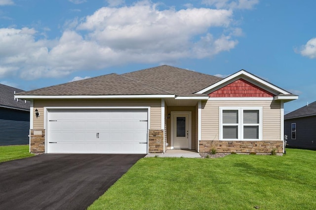 craftsman-style house featuring a shingled roof, aphalt driveway, a front yard, stone siding, and an attached garage