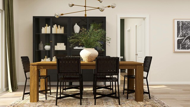 dining area with a notable chandelier, wood finished floors, and baseboards