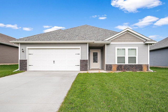 view of front of property featuring a shingled roof, concrete driveway, a front lawn, a garage, and stone siding