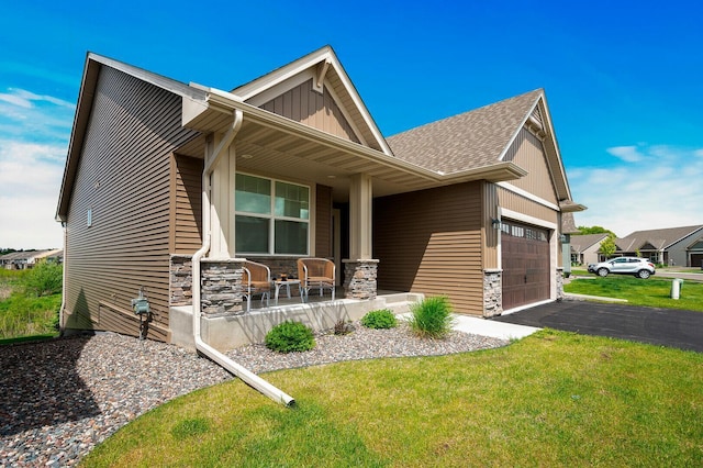 craftsman inspired home featuring a porch, stone siding, an attached garage, and board and batten siding