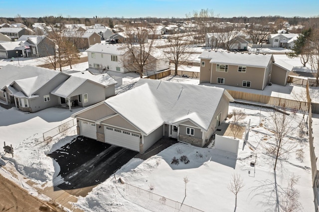 snowy aerial view featuring a residential view