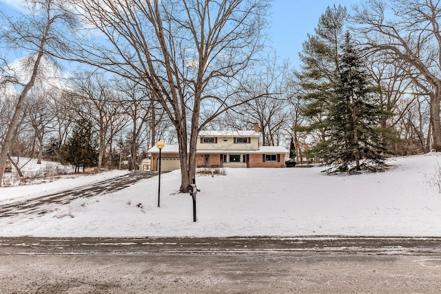 view of front of property featuring a garage and brick siding