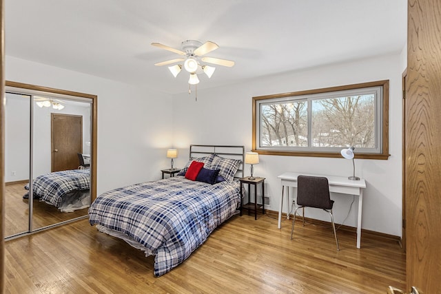 bedroom featuring ceiling fan, baseboards, and wood finished floors