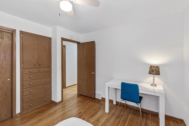 office with ceiling fan, light wood finished floors, visible vents, and baseboards