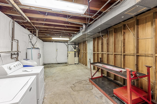 unfinished below grade area with water heater, washer and clothes dryer, concrete block wall, and heating unit