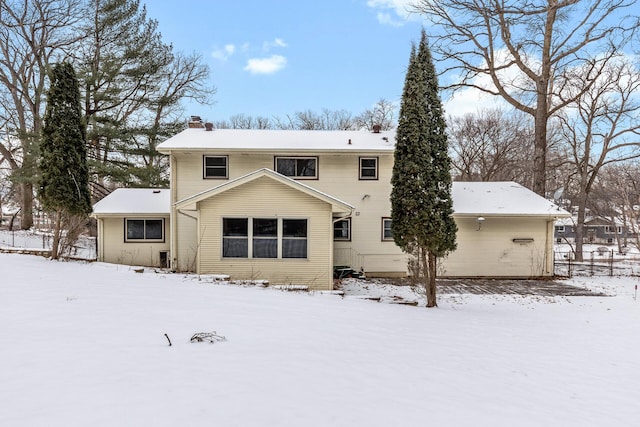 snow covered house with a chimney