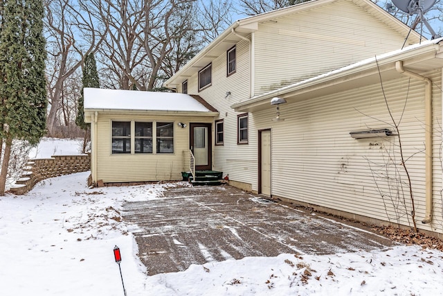 snow covered house with entry steps