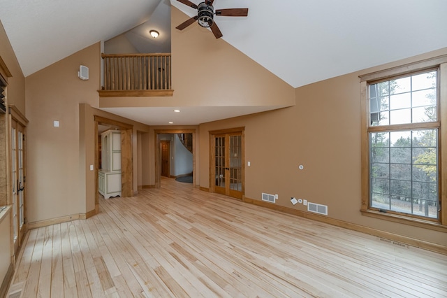 unfurnished living room with a wealth of natural light, light wood finished floors, and visible vents