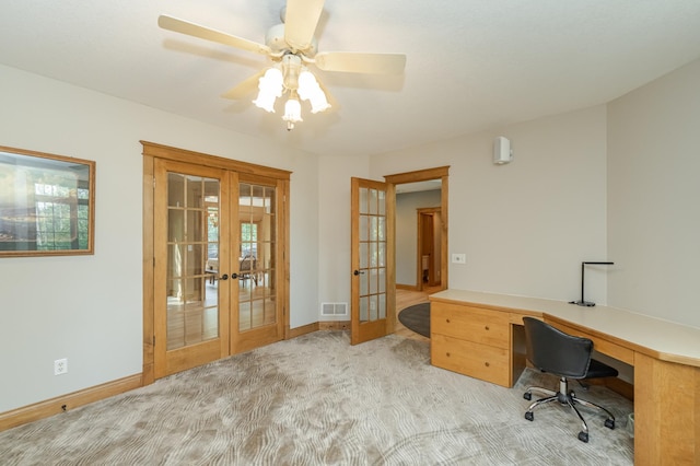 office space featuring french doors, visible vents, light carpet, and baseboards