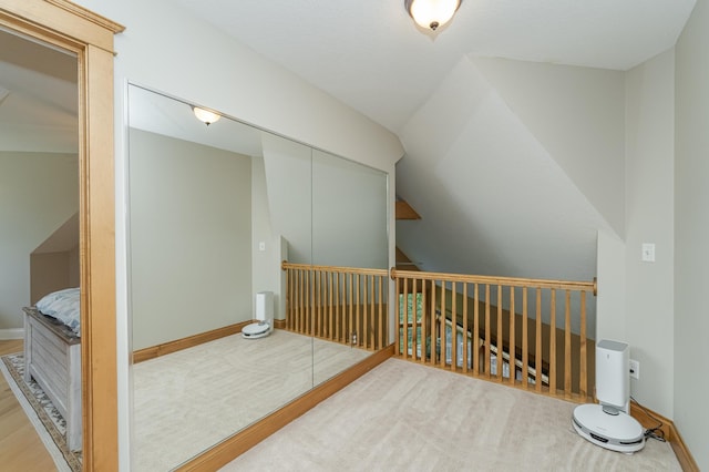 additional living space with carpet, baseboards, and vaulted ceiling