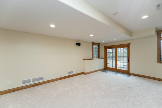 carpeted spare room featuring recessed lighting, visible vents, and baseboards